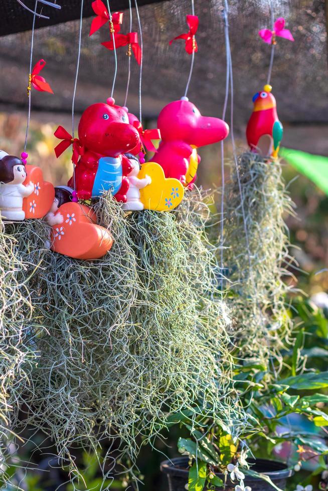 Hermit beard grass with hanging ceramic dolls. photo