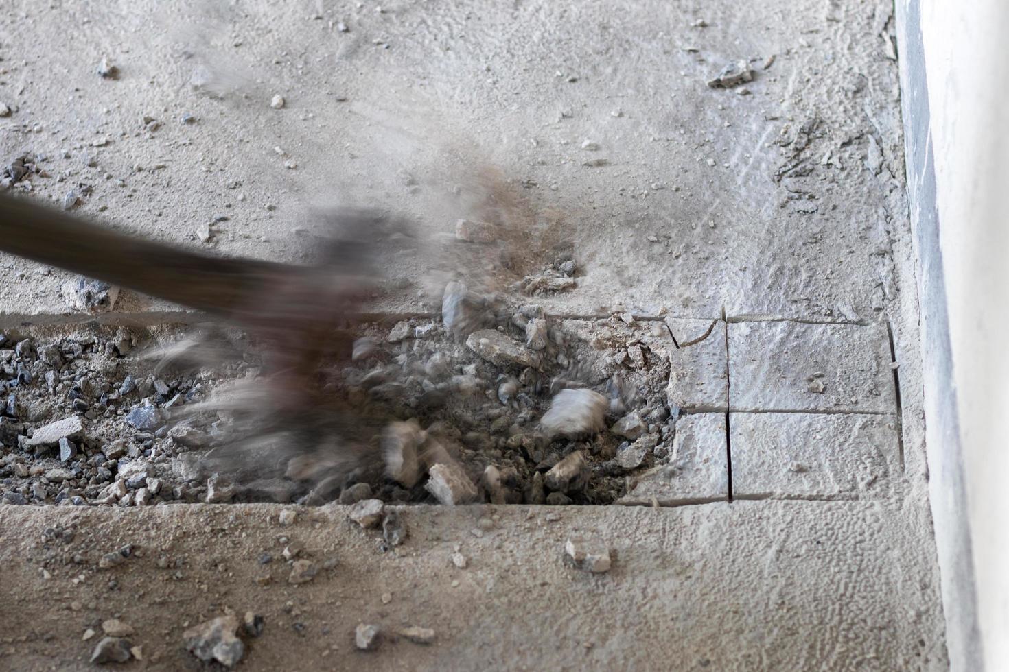 A large hammer bashed into the concrete. photo