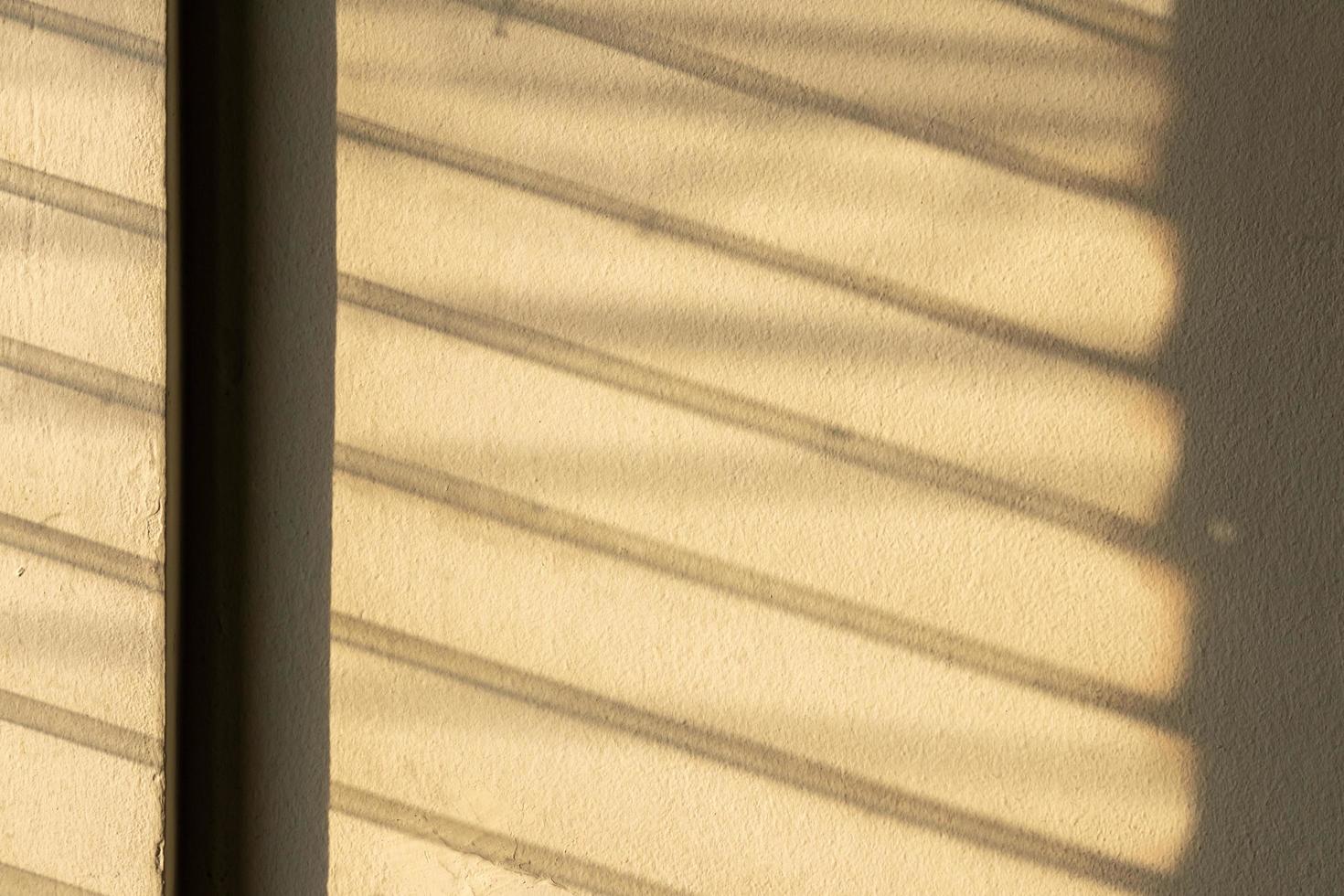 Sunlight shadow on the wall from the louver window. photo