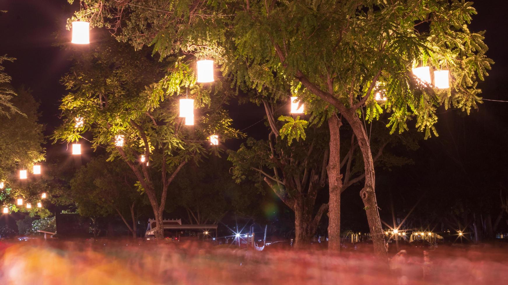 Lanterns on the tree with people blurred motion. photo