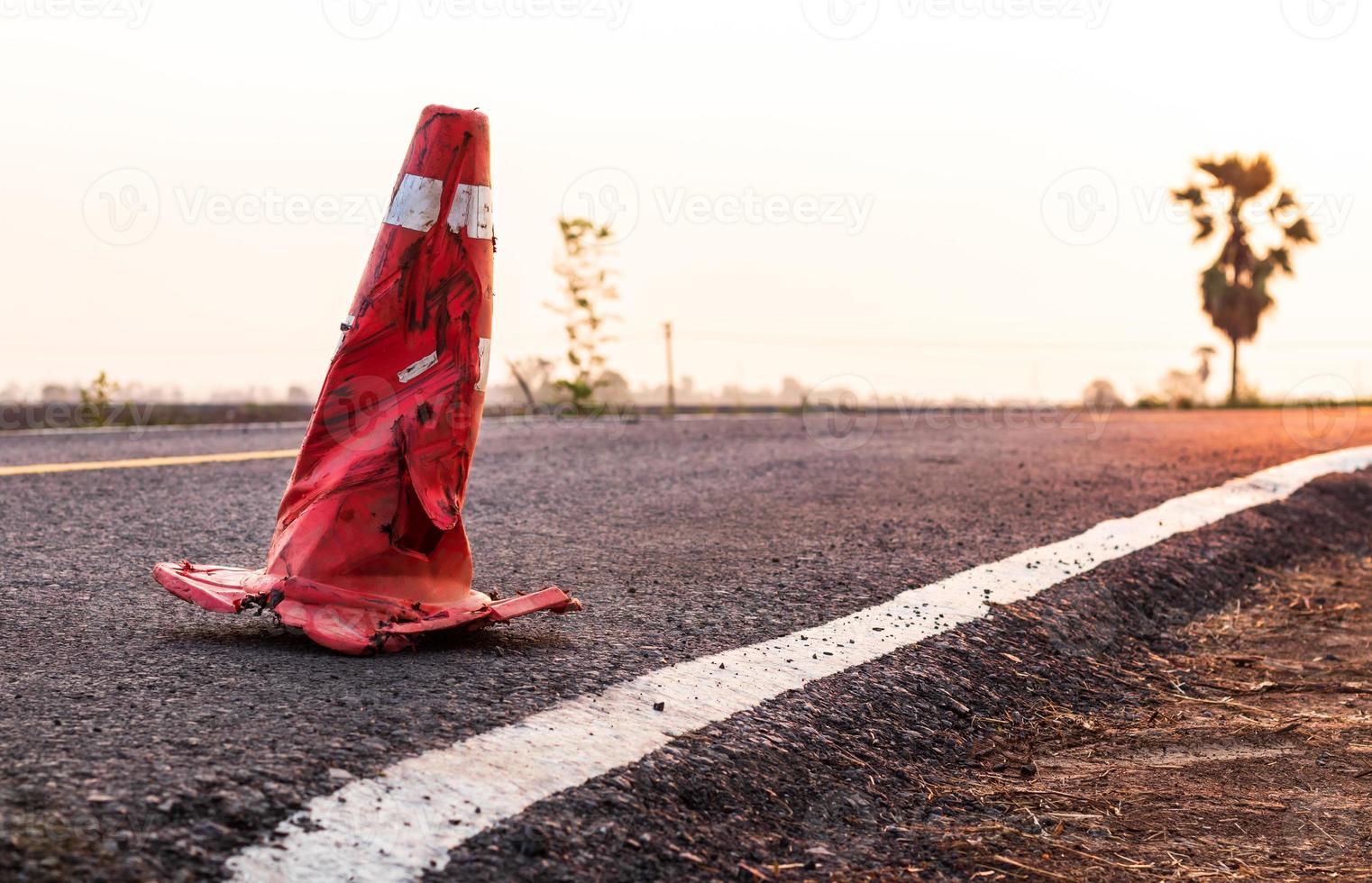 The rubber cone was demolished on the paved road. photo