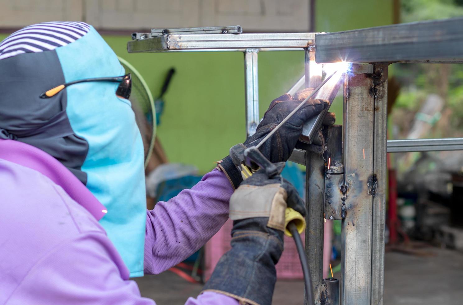 Welding of steel and fabric covering the face. photo