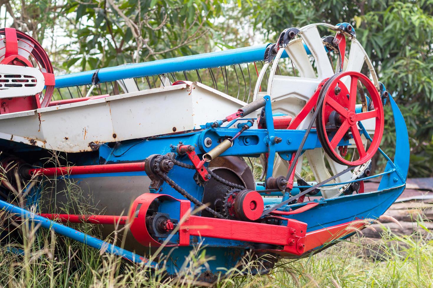 The front of the combine harvesters is blue and red. photo