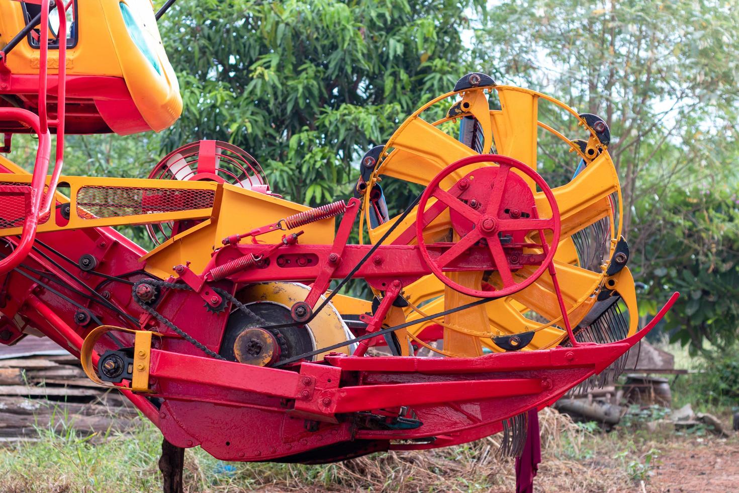 The front of the combine harvesters is yellow and red. photo