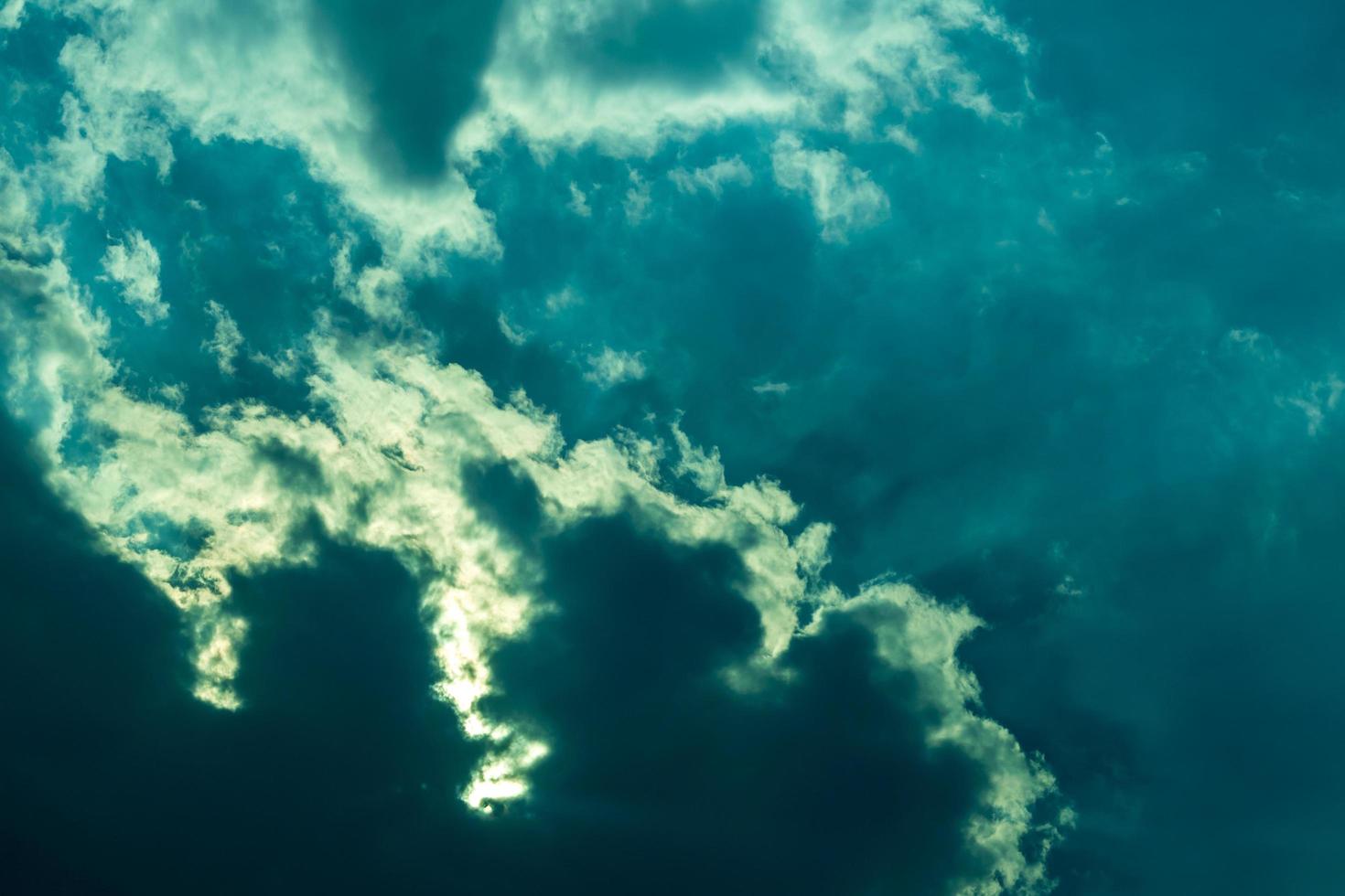 Background of overcast clouds with light shining through the sky. photo