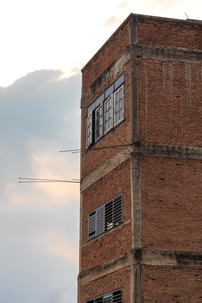 Corner building, old brick wall. photo