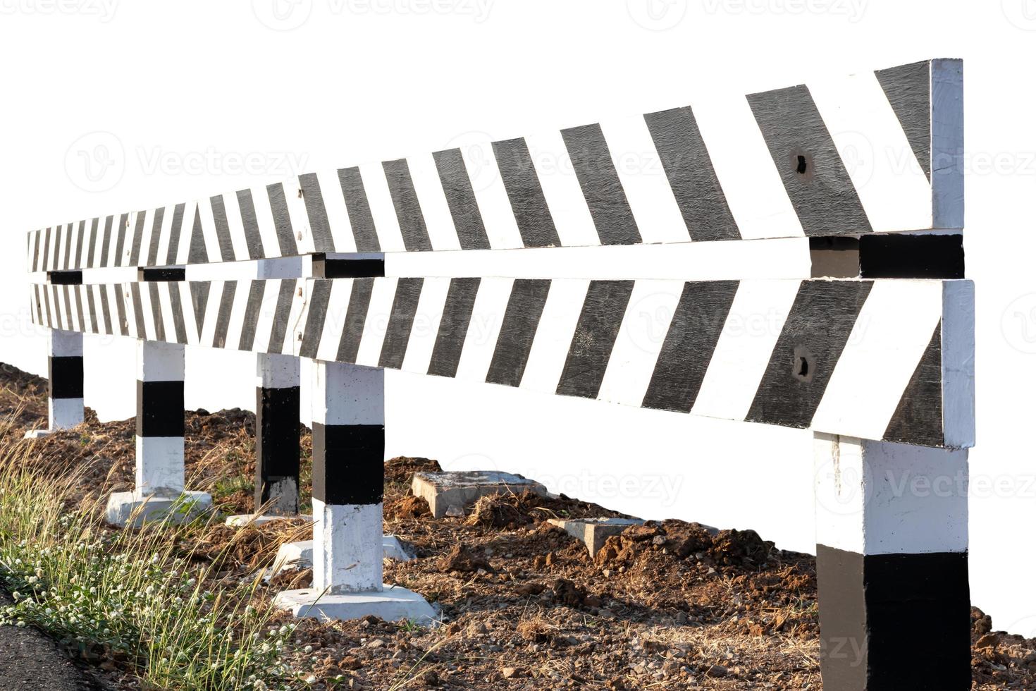 Isolated black-and-white fence that blocks the way. photo