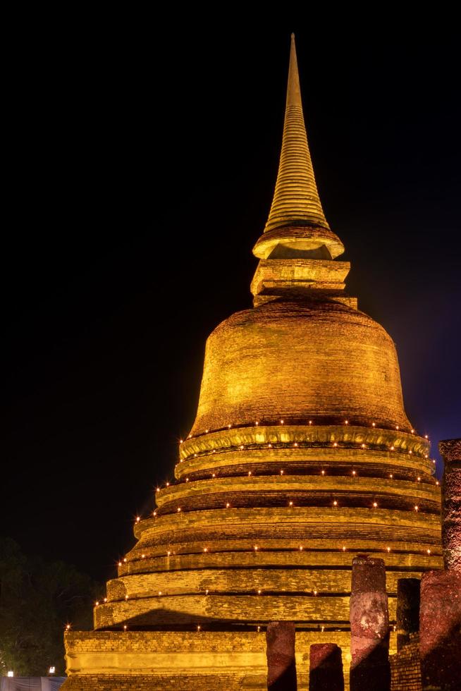 Old brick pagoda with light in the dark. photo