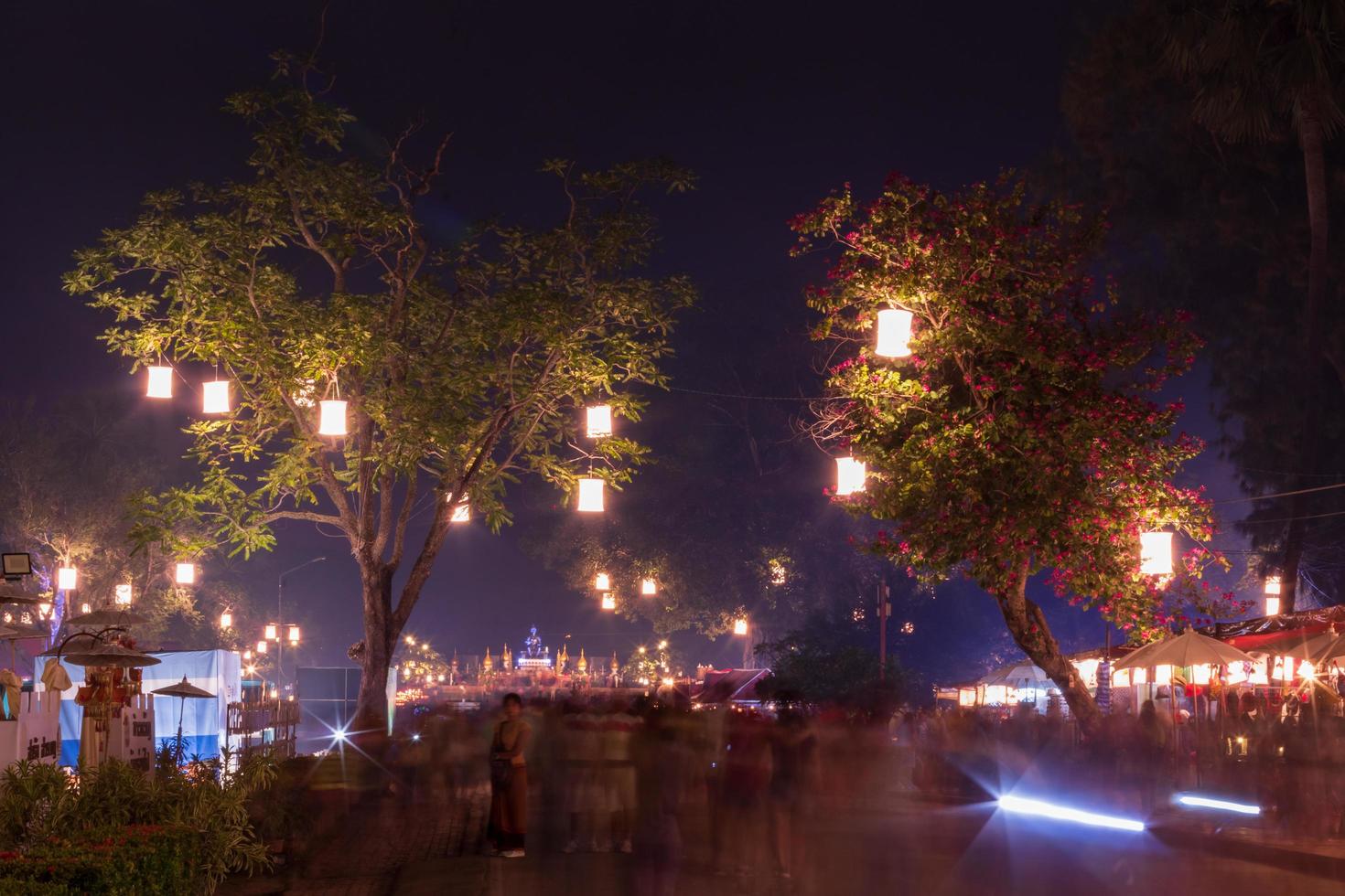 Lanterns on the tree with people blurred motion. photo
