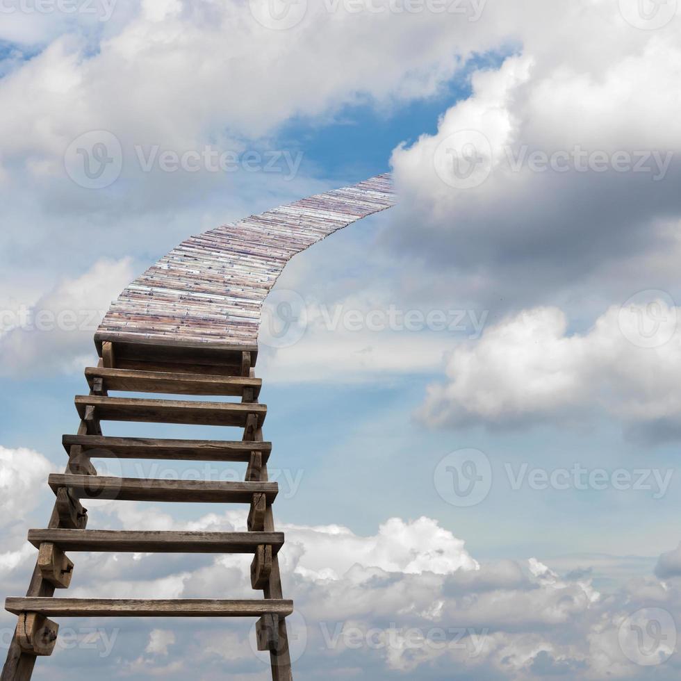 Wooden stairs and bamboo bridge to overcast clouds. photo