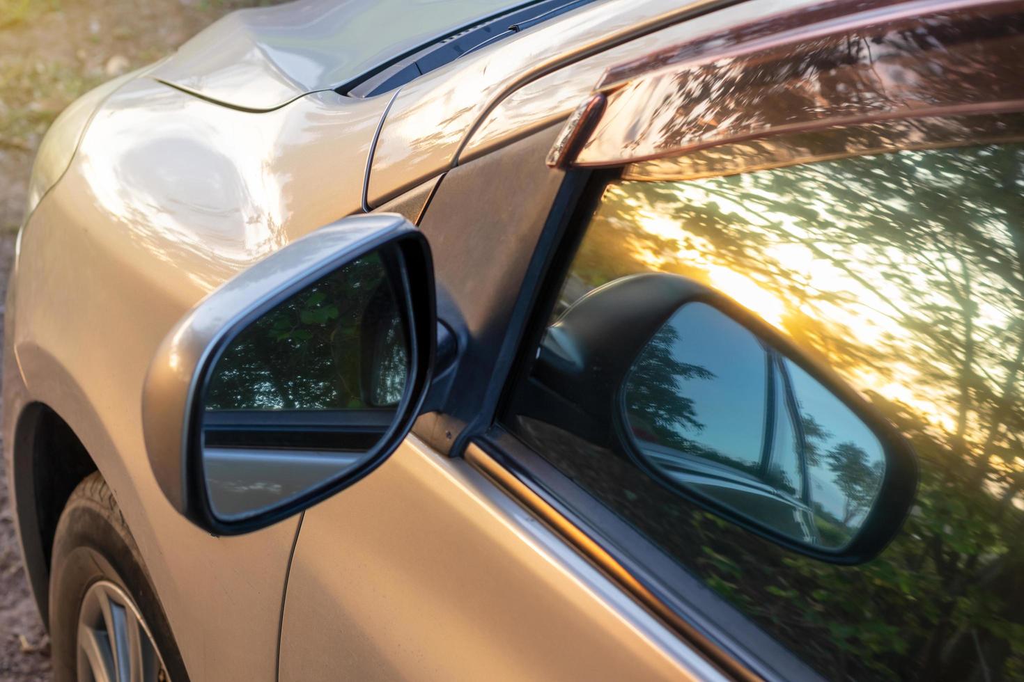 Sunrise in the early morning, reflecting the mirror outside the car. photo