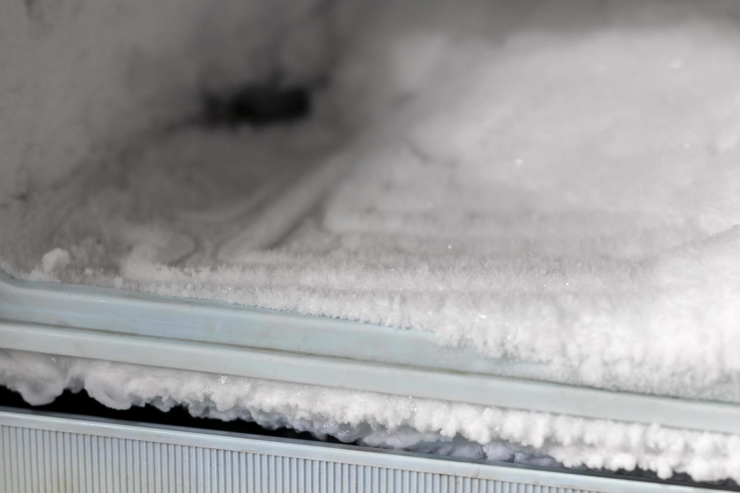 Lots of ice in the freezer of the old refrigerator. photo