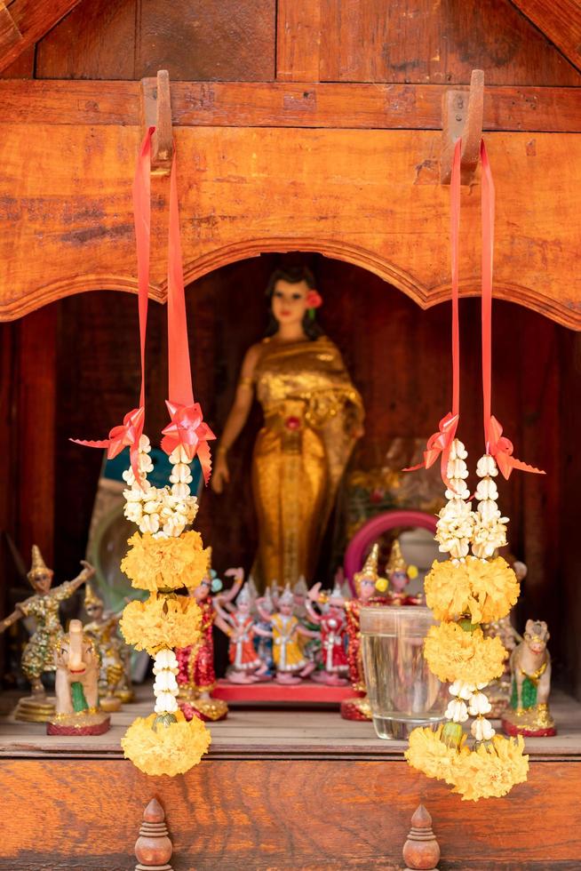 Garland of flowers on a wooden shrine. photo