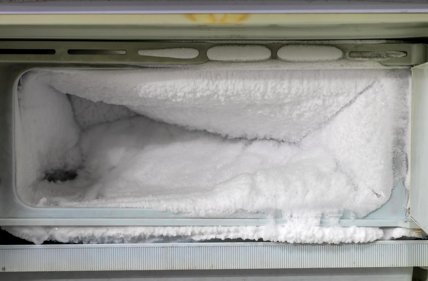 Lots of ice in the freezer of the old refrigerator. photo