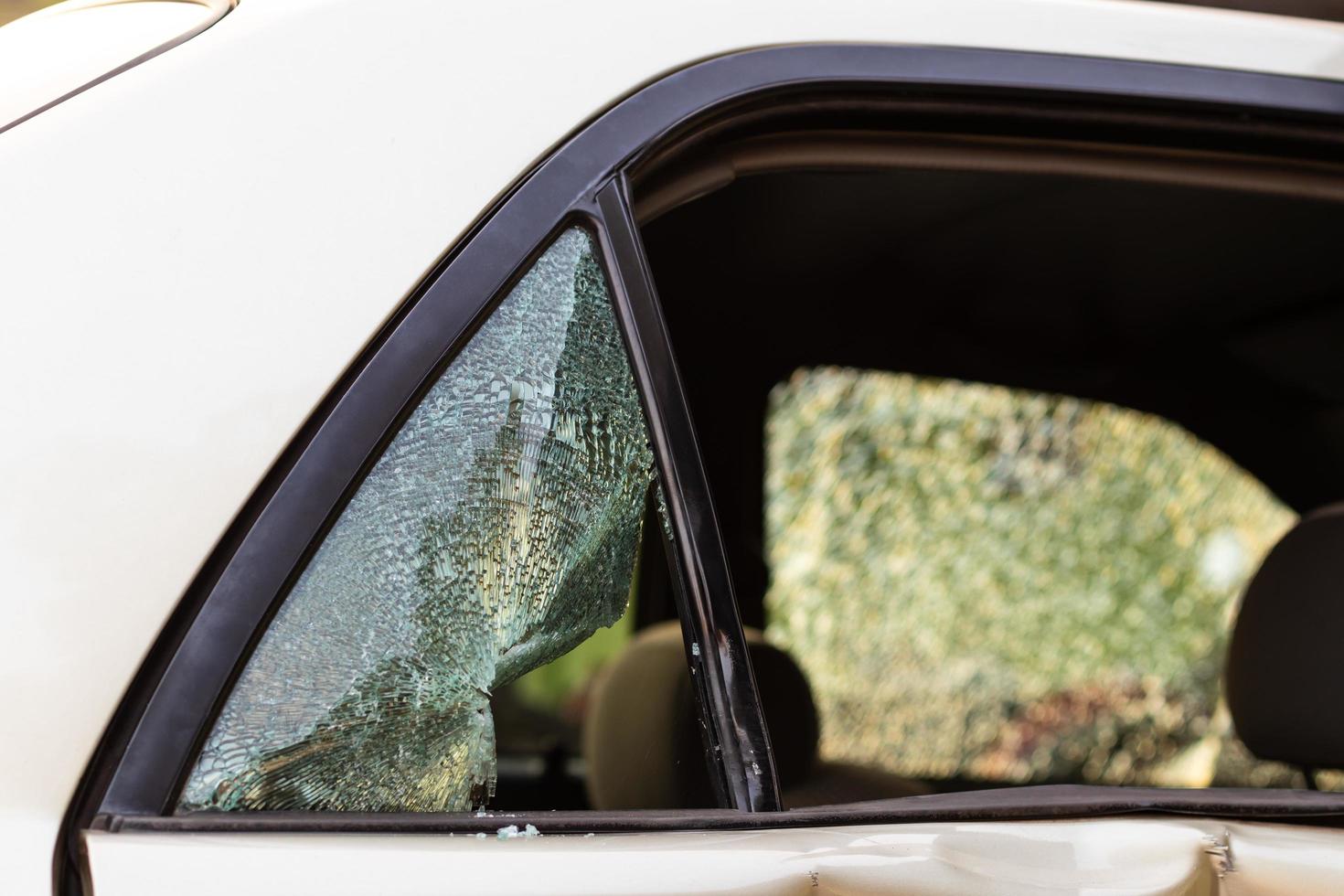 Car door glass which was cracked and damaged in an accident. photo