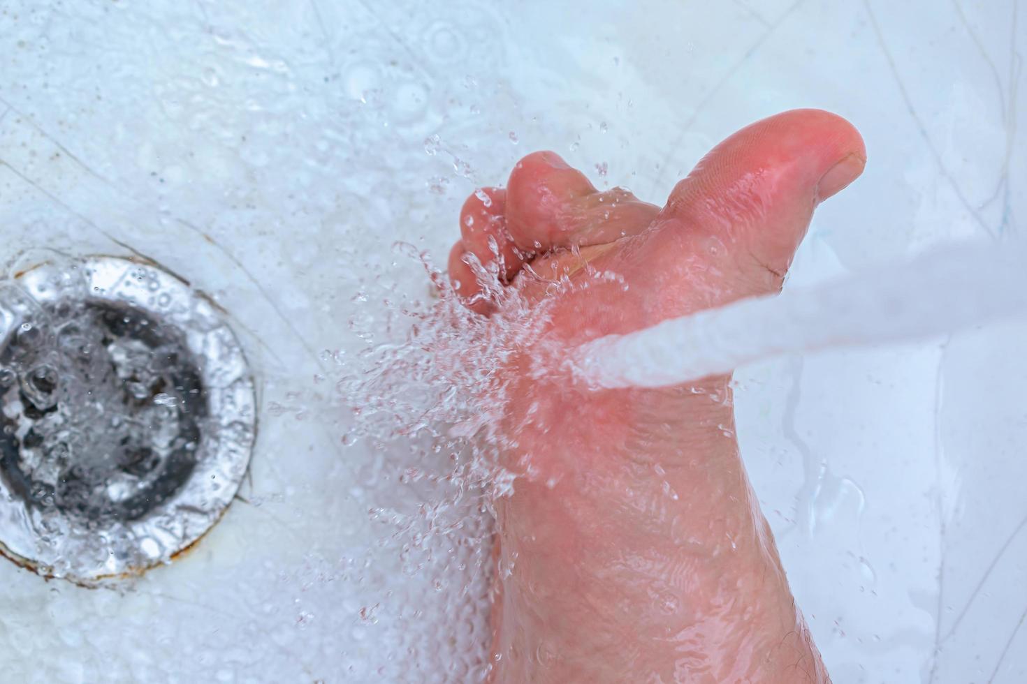 Washing feet with warm running water in the bath to prevent foot fungus 7676133 Stock Photo at