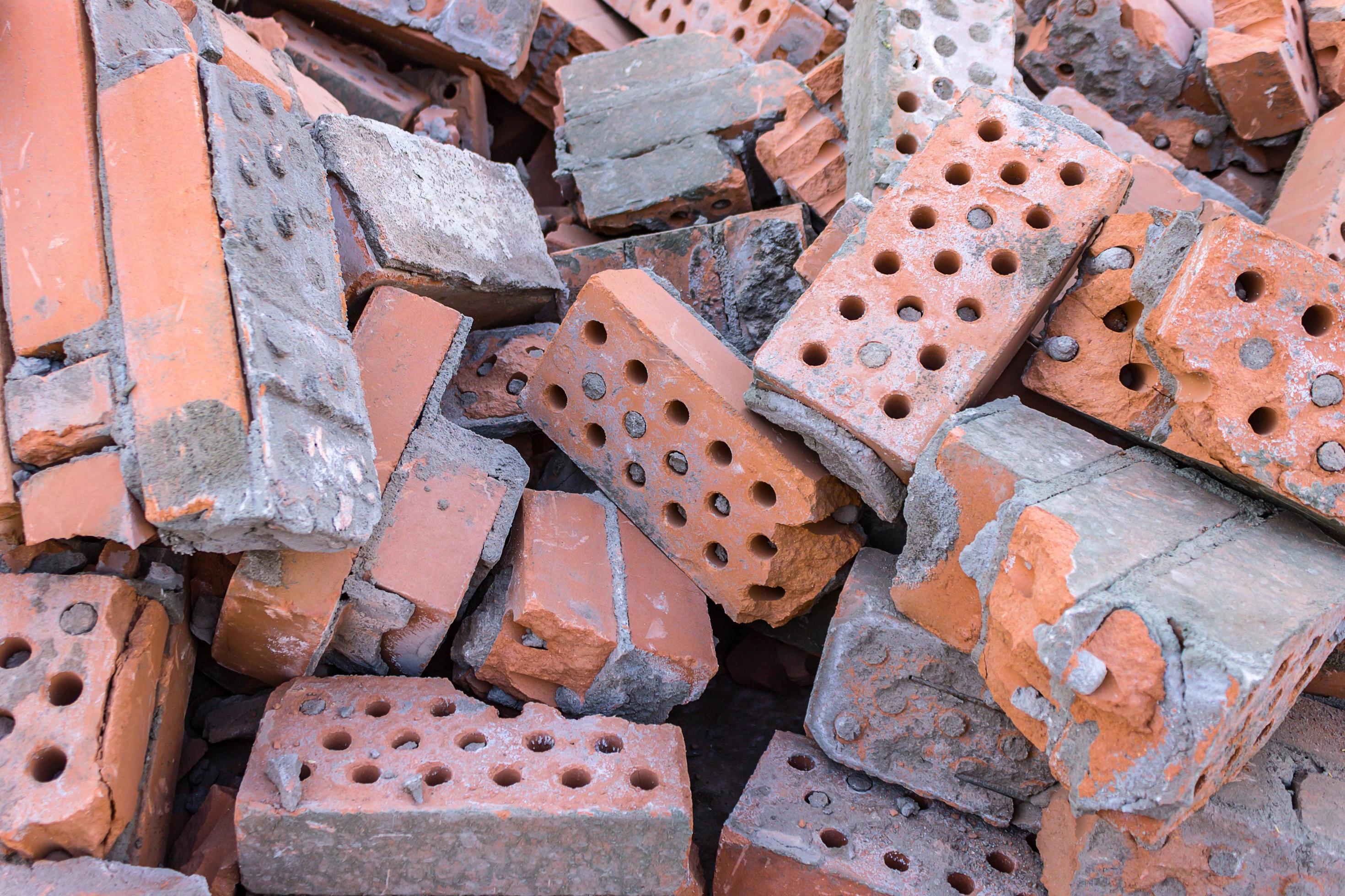 A pile of broken bricks after the demolition of a building. Landfill of old building material