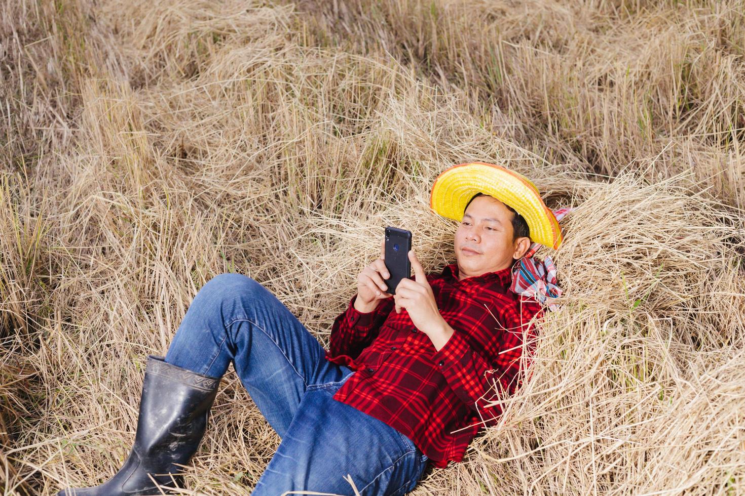 Asian farmer with rice stubble in the field photo