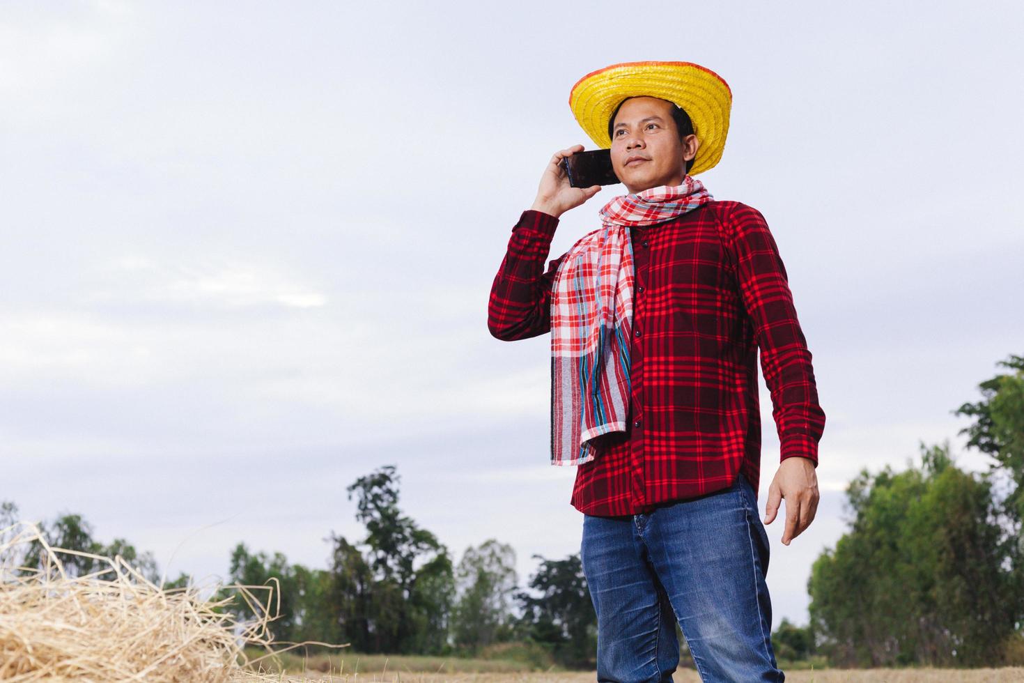 Asian farmer with rice stubble in the field photo