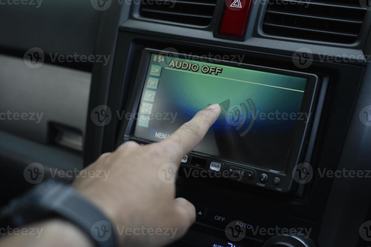 Finger pointing at the screen in the car photo