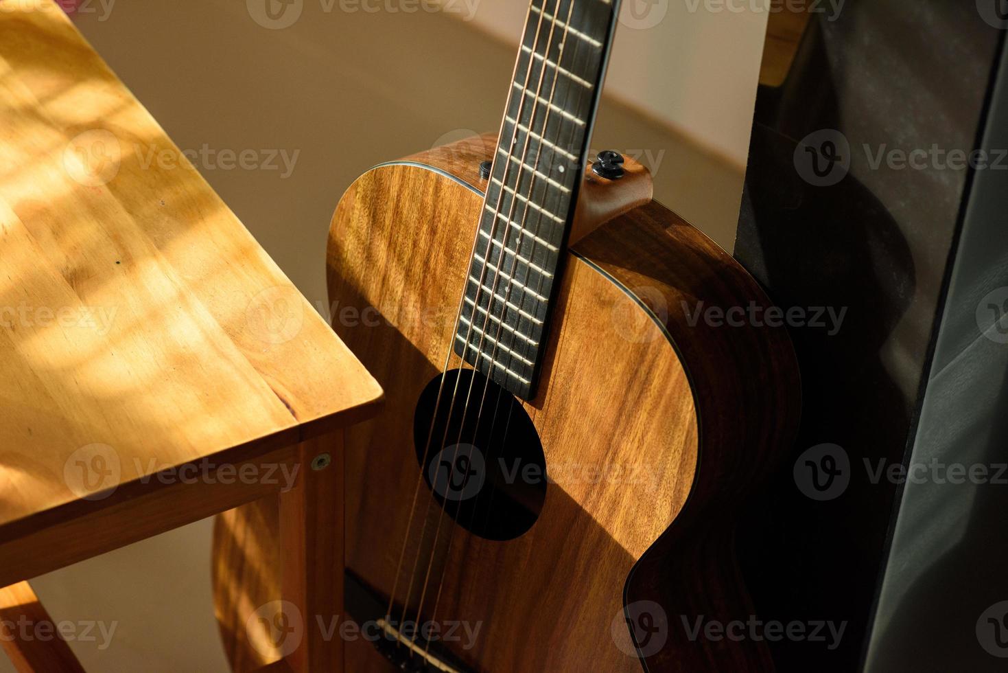 Acoustic guitar close-up on a beautiful colored background, the concept of stringed instruments photo