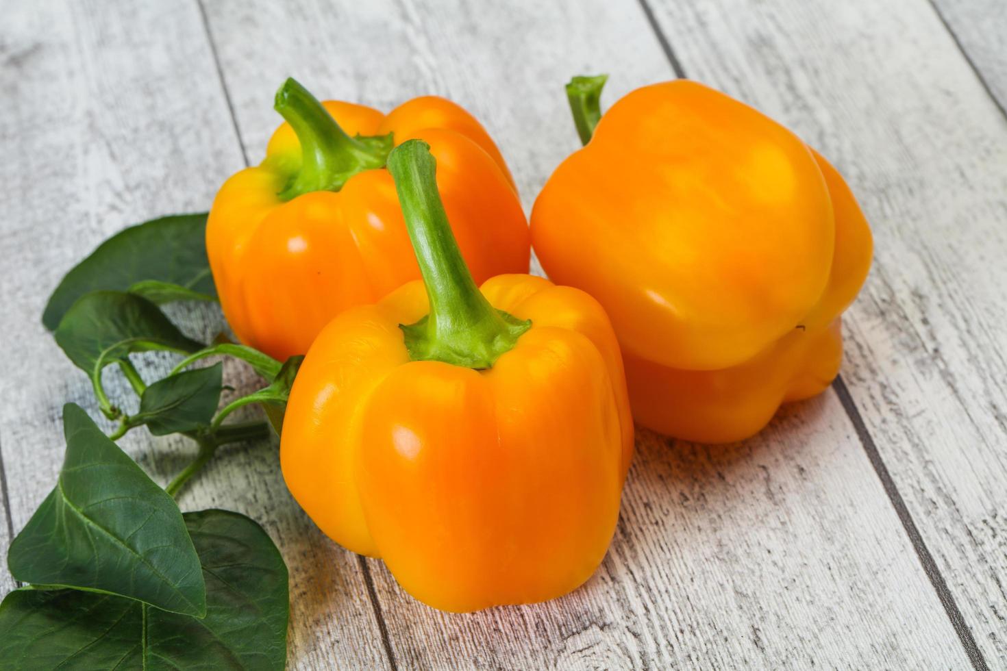 Yellow Bell pepper with leaves photo