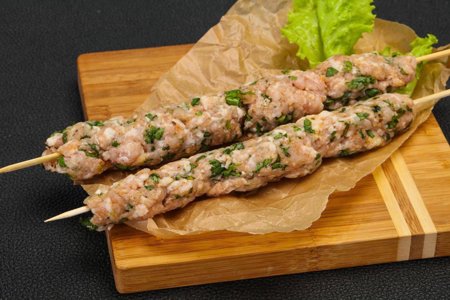 Raw minced pork skewer kebab for grill photo