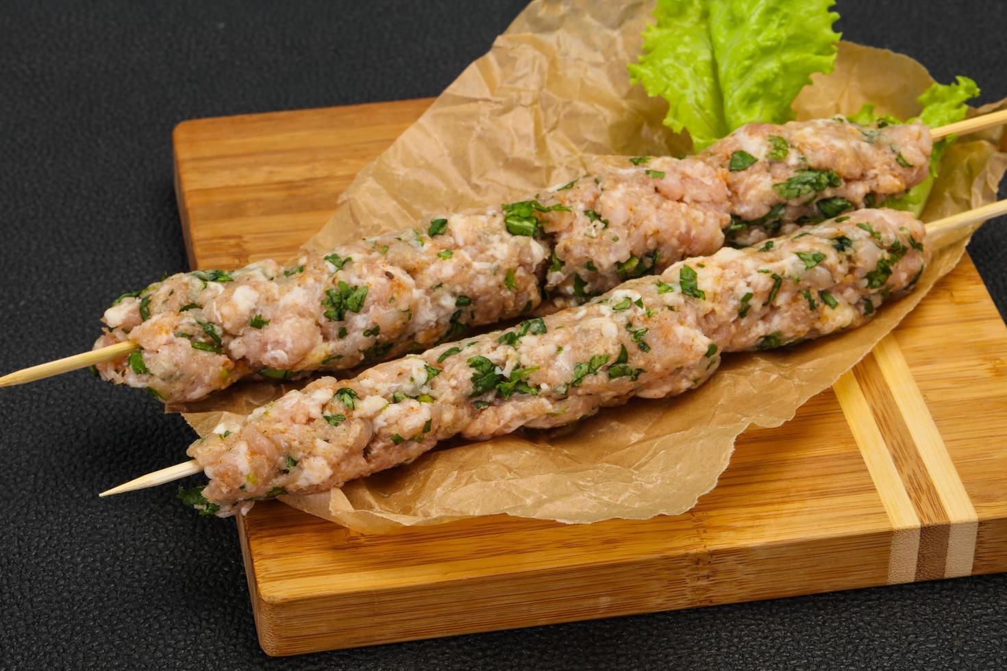 Raw minced pork skewer kebab for grill photo