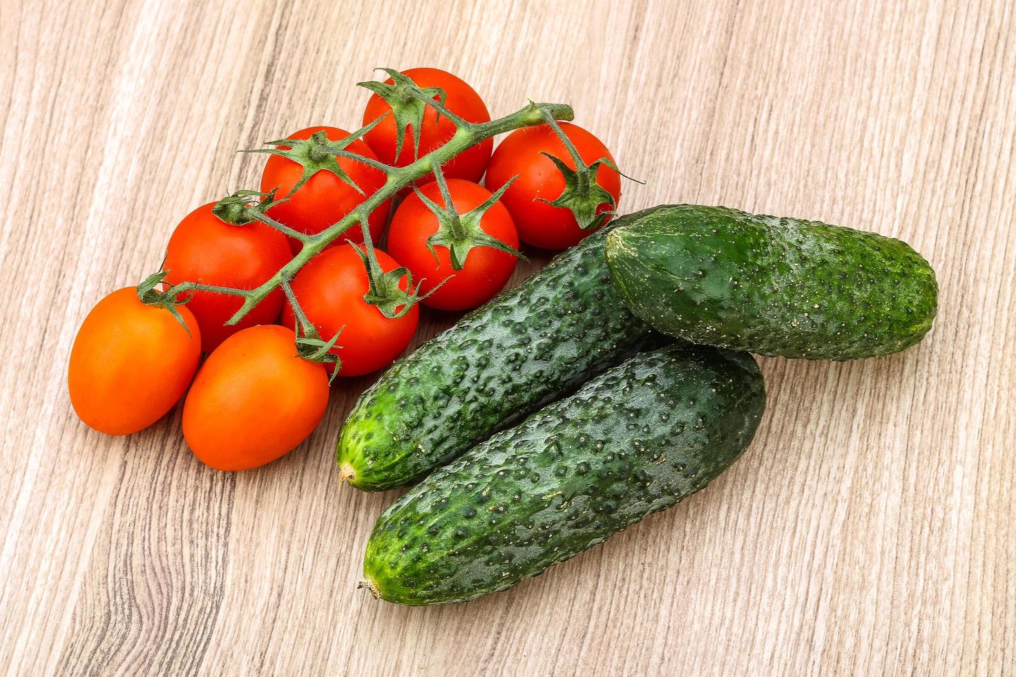 Cucumbers and tomatoes on the branch photo