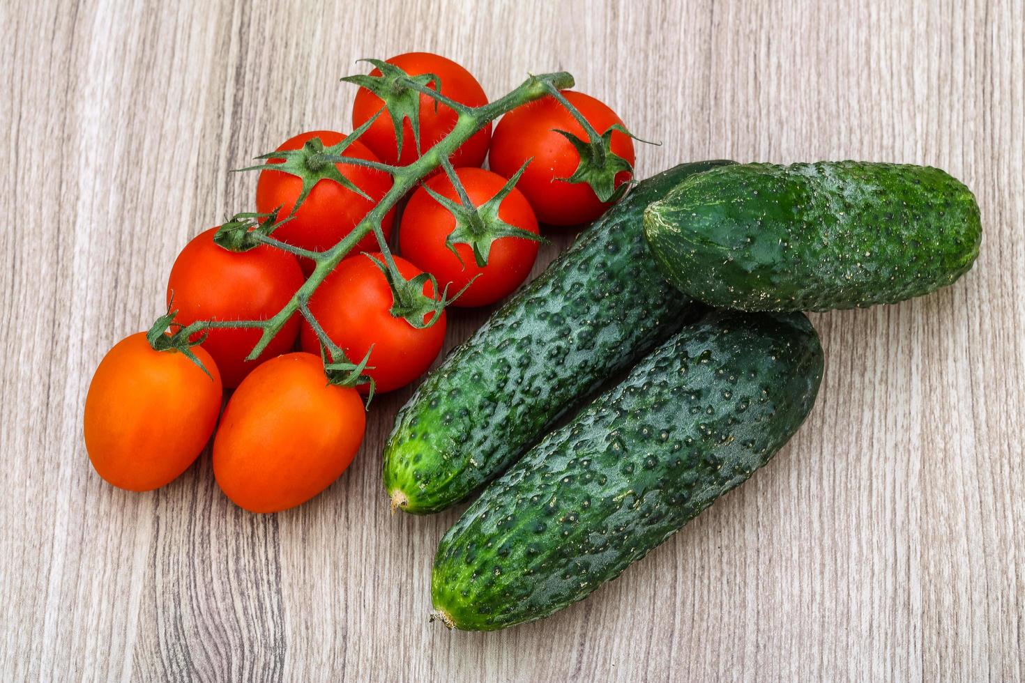 Cucumbers and tomatoes on the branch photo