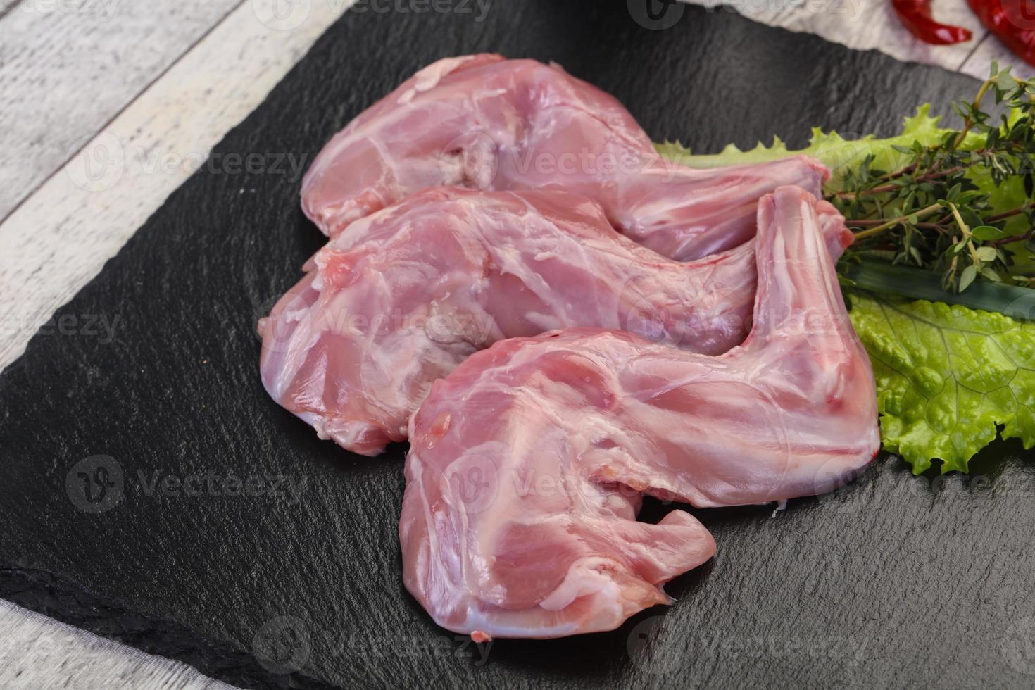 Raw rabbit legs photo