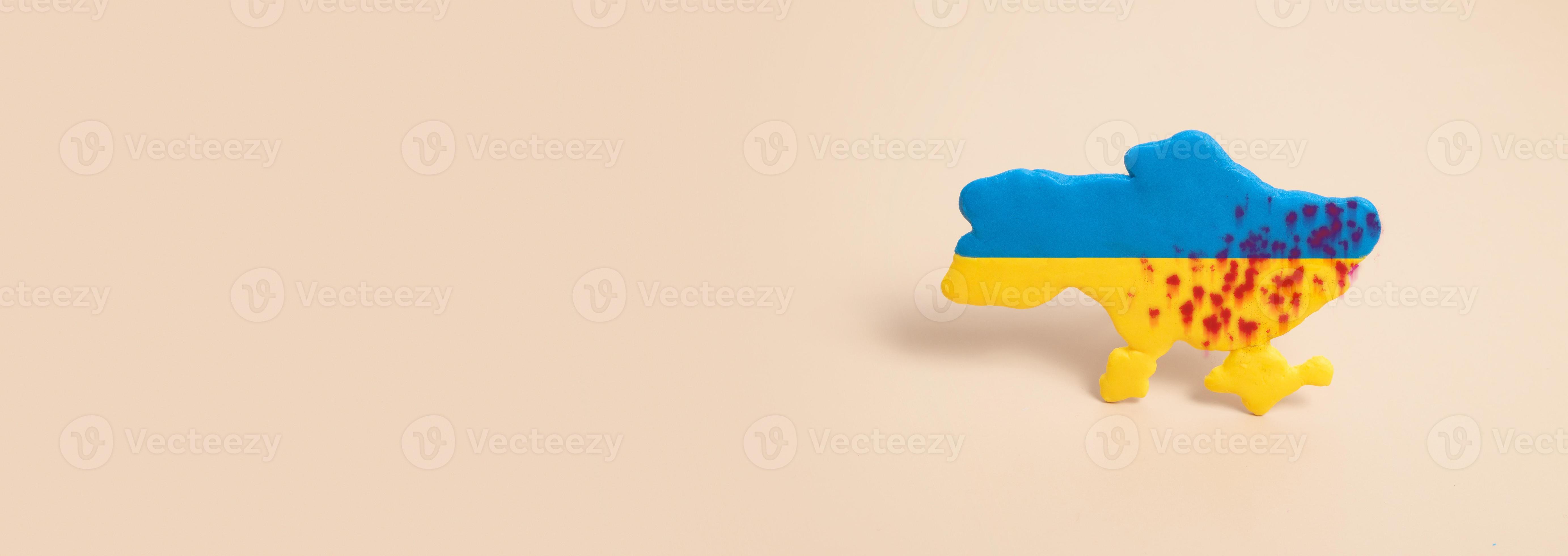 Plasticine yellow and blue map of Ukraine with shots in the blood with copy  space banner format. War in Ukraine concept 7687519 Stock Photo at Vecteezy