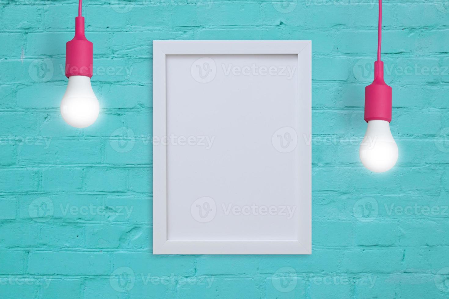 Mock-up frame on a turquoise brick wall with light bulbs. Insert your text or image photo