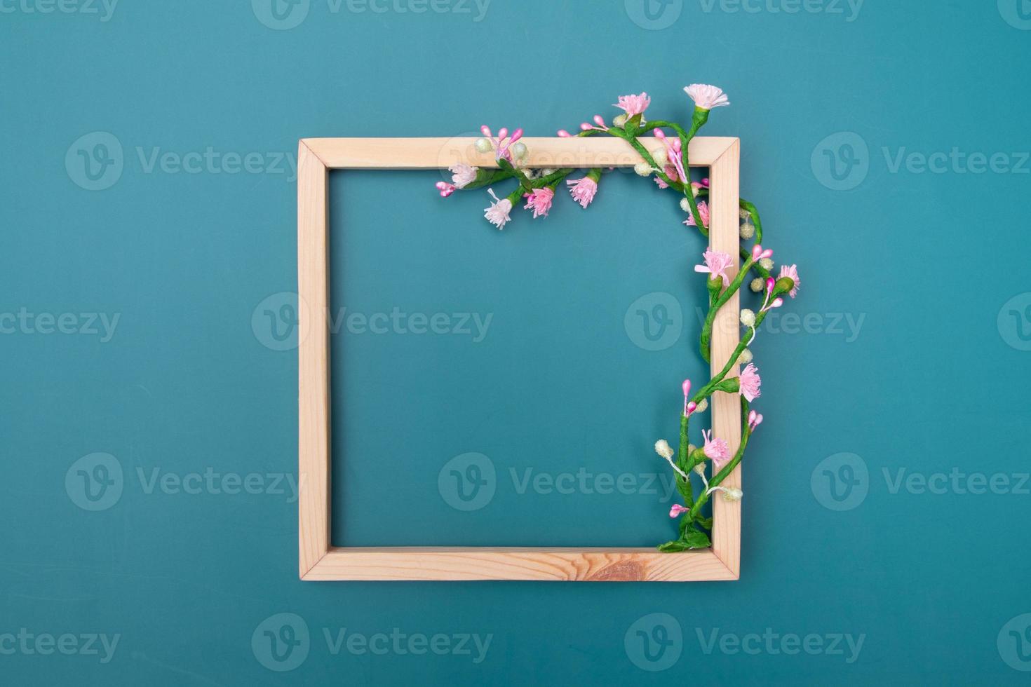 Square wooden frame mock up with decorative floral ornaments with copy space top view photo