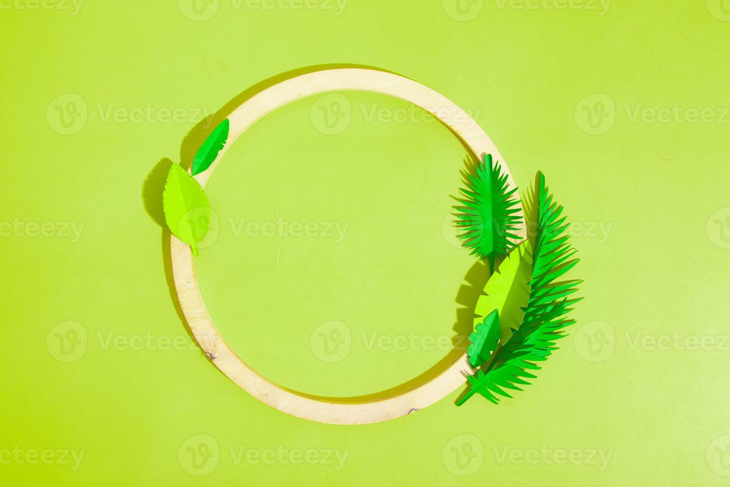 Wooden frame with tropical leaves with copy space top view photo