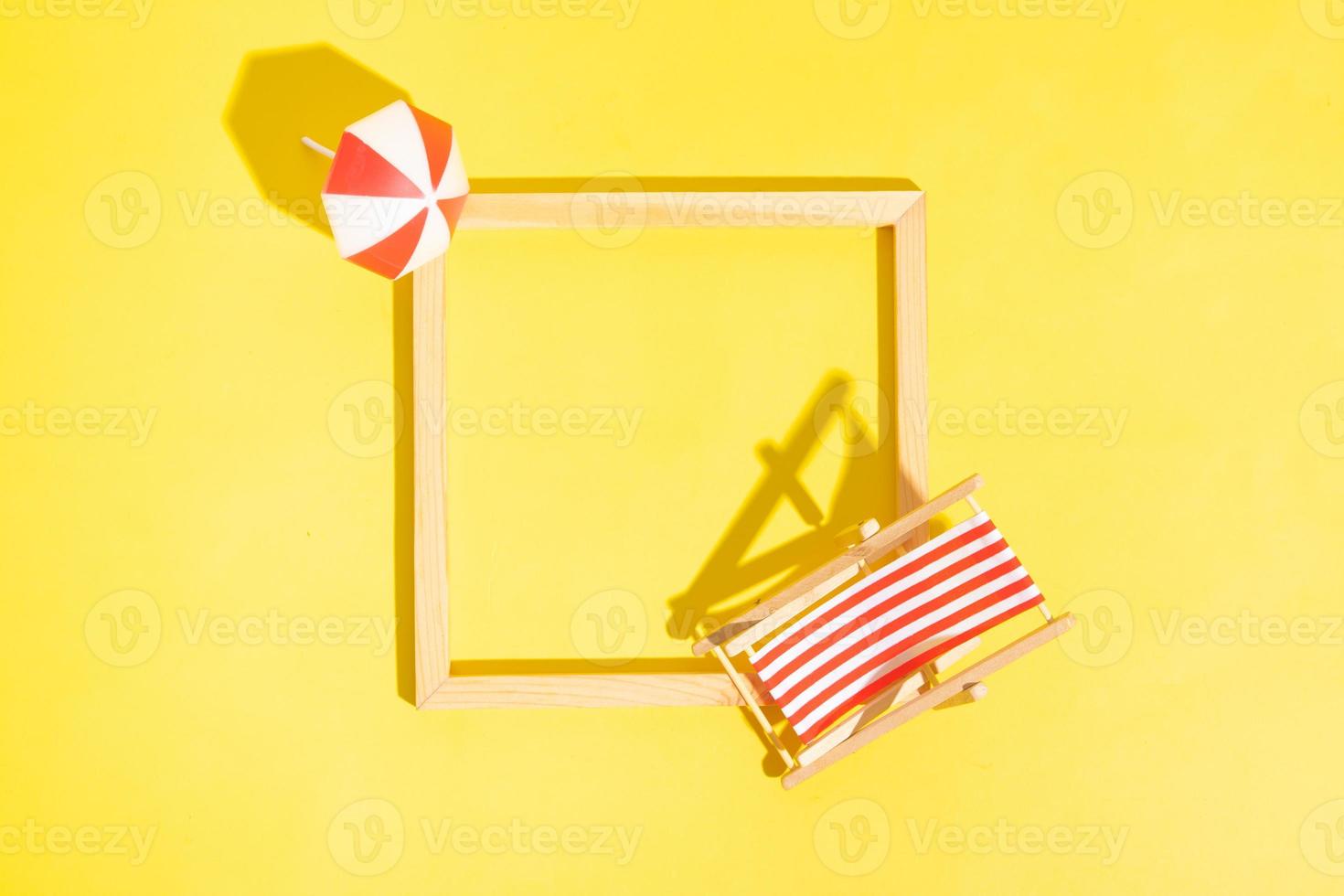 Wooden frame with beach chair and umbrella with copy space top view photo