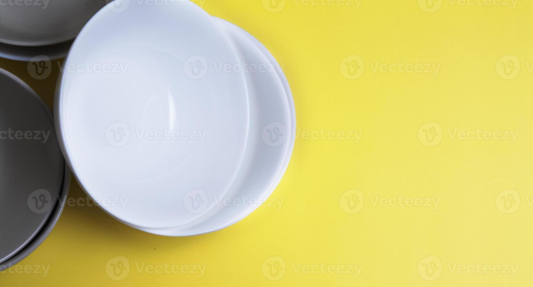 Top view empty plates on yellow background with copy space photo