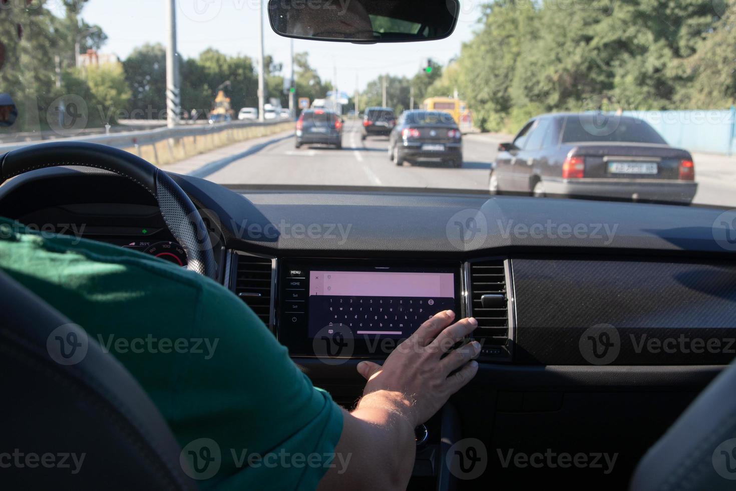 Car interior on the road. Steering wheel, dashboard and on-board display photo