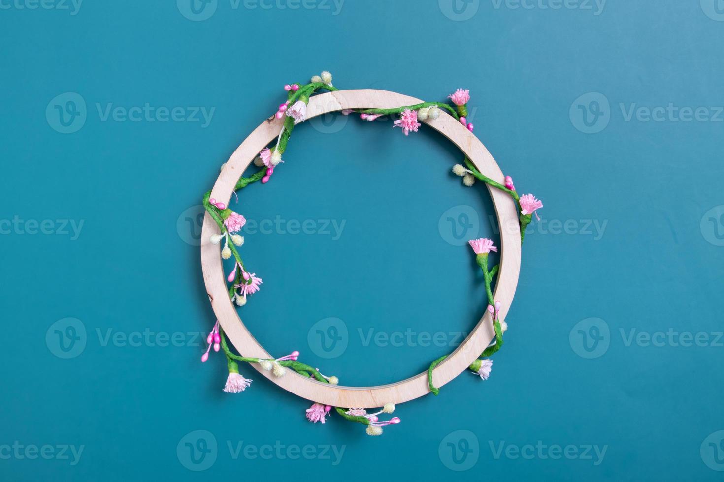 Round wooden frame with copy space decorated with floral pattern photo