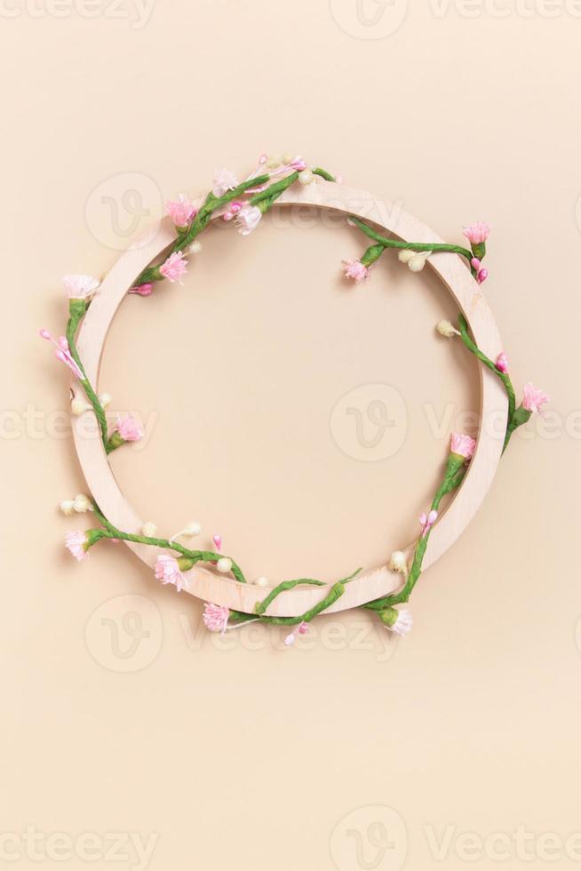 Round wooden frame with copy space decorated with floral pattern. Vertical format photo