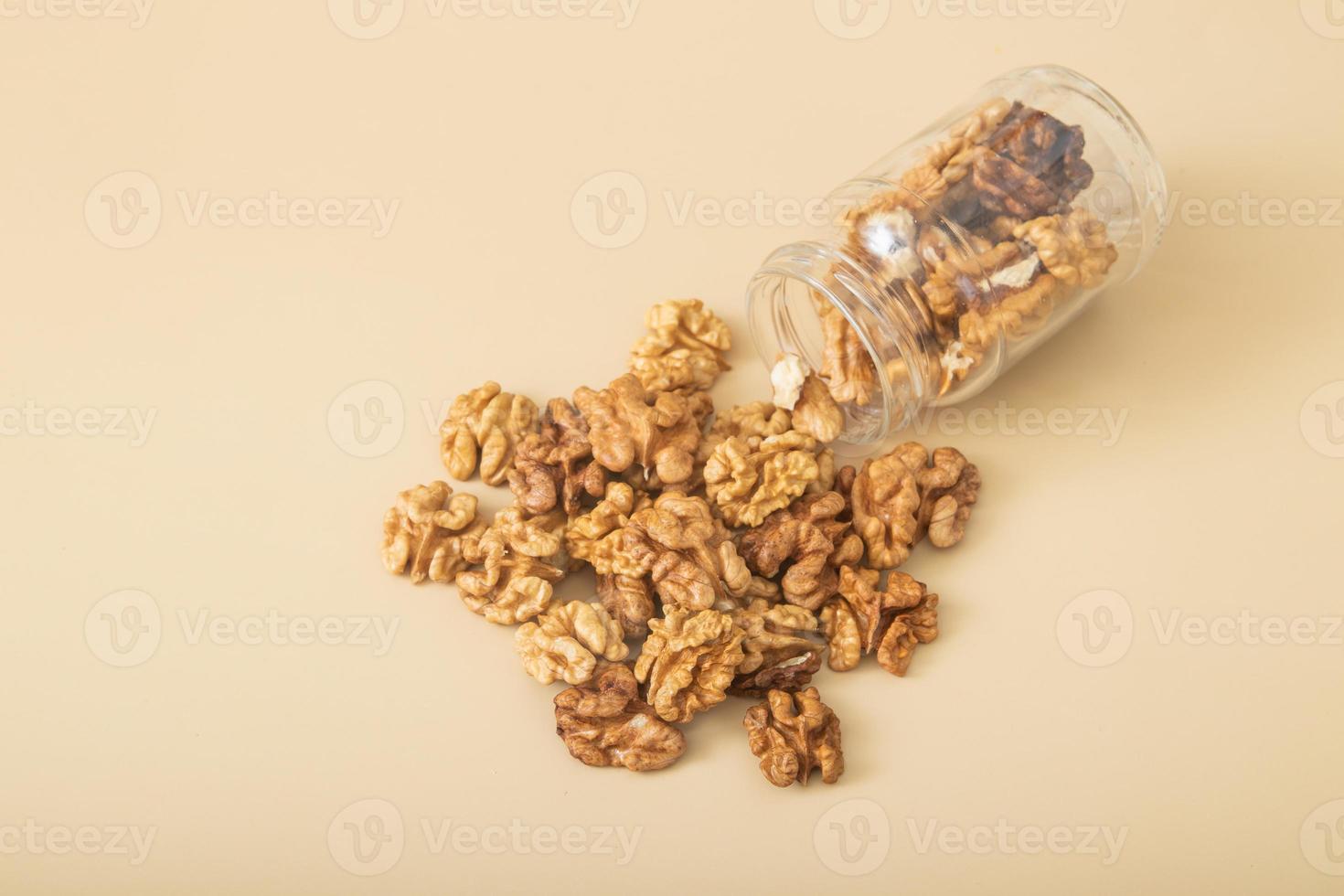 Jar of peeled halves of walnuts top view photo