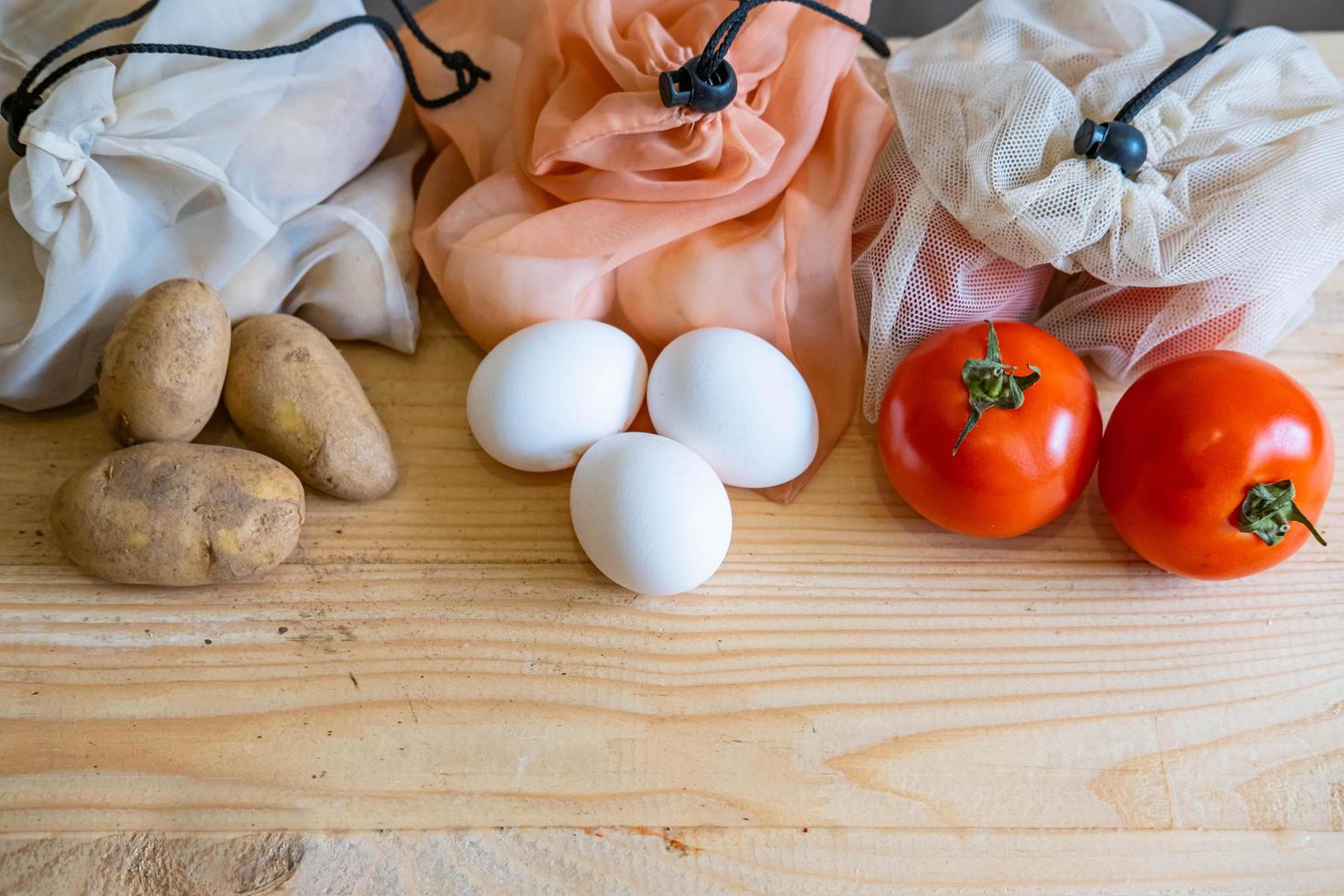 Colorful fresh fruits vegetables and eggs  in eco friendly bags photo