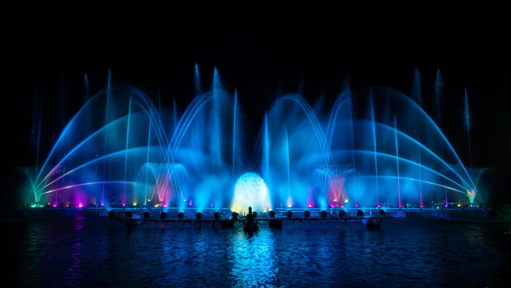 The colorful fountain dancing in celebration of year with dark night sky background. photo