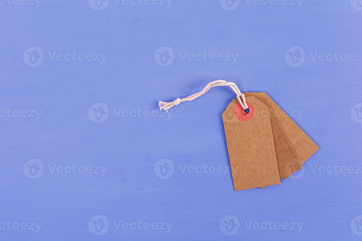 Blank label tag isolated on blue background. Price tag. Sale concept. photo