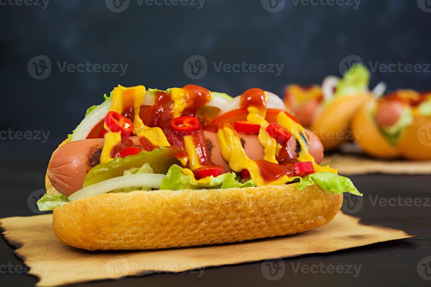 Delicious homemade hot dog on dark background photo