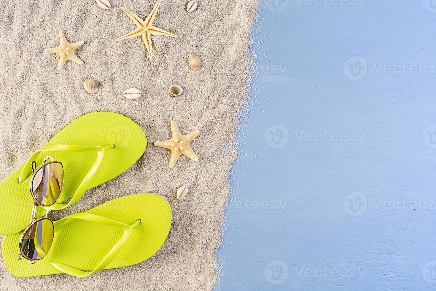 Summer background. Sea sand with seashells, starfish and sunglasses. Summer vacation concept photo