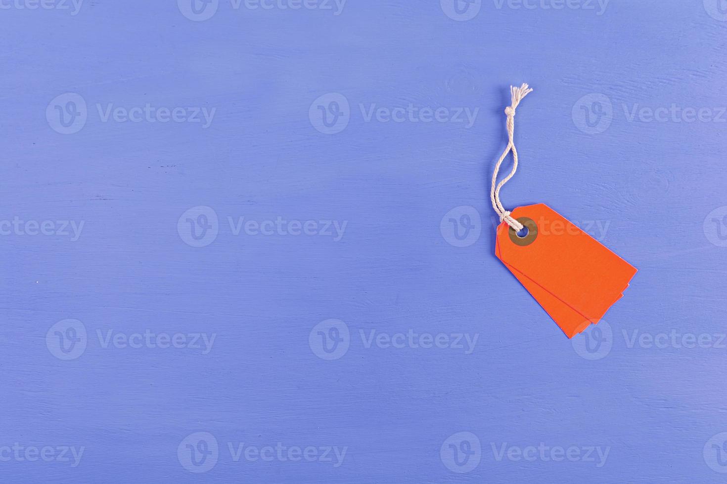 Blank label tag isolated on blue background. Price tag. Sale concept. photo