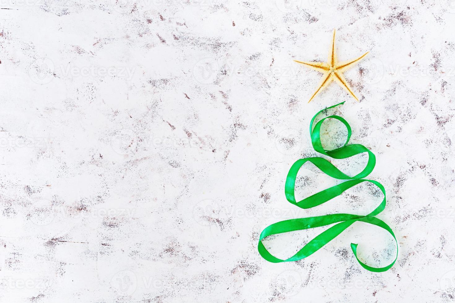 Christmas tree made of ribbon and starfish on white background. Top view photo