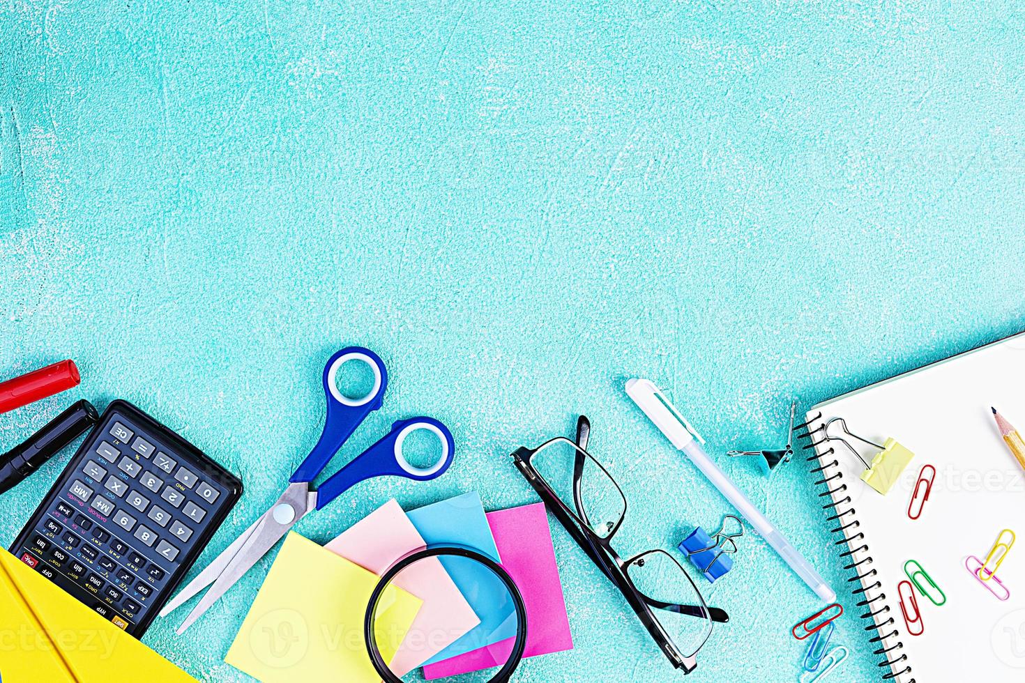 Different school supplies on blue background. Concept Back to school photo