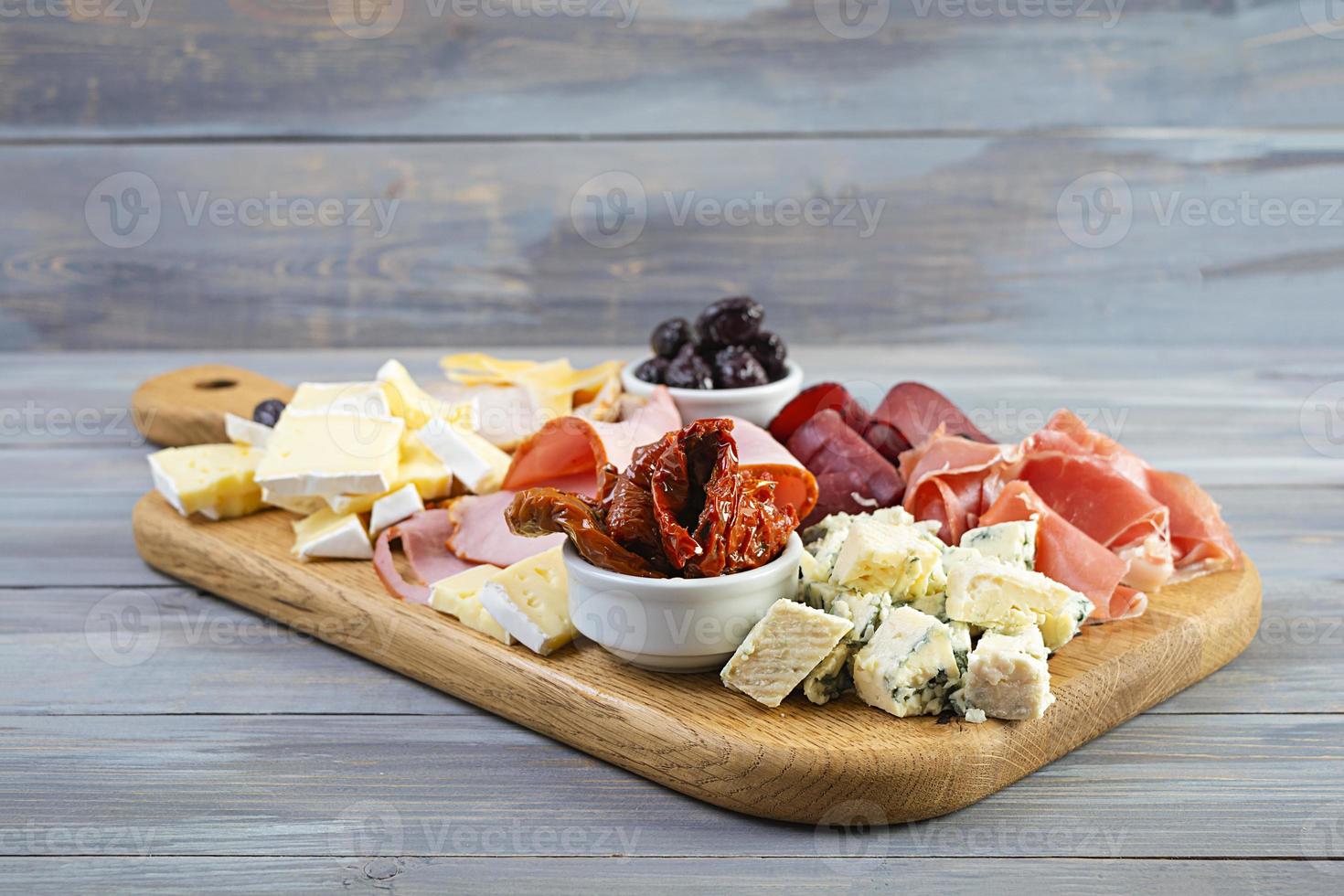 Italian antipasto. Antipasti board with ham, salsami, prosciutto, parmesan, blue cheese and